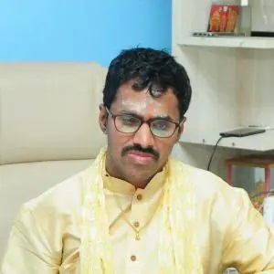 a man with glasses and a mustache is sitting on a couch