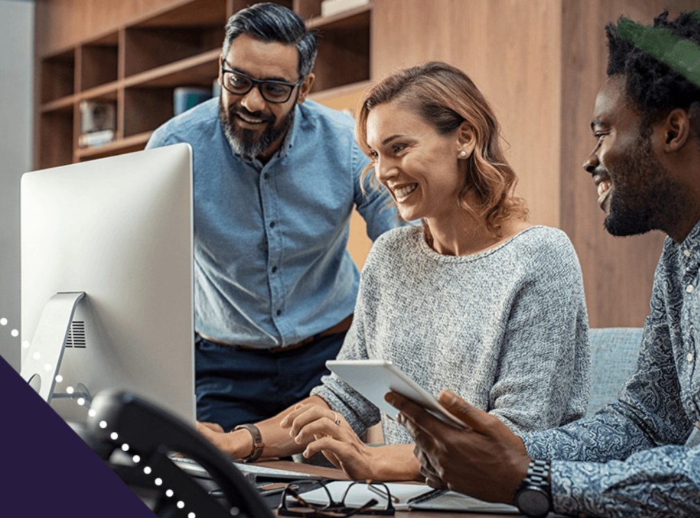 a group of people are looking at a computer screen