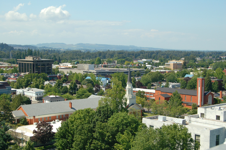 an aerial view of a city with a church in the foreground