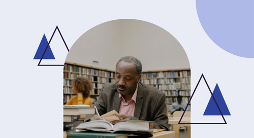 man in library taking notes