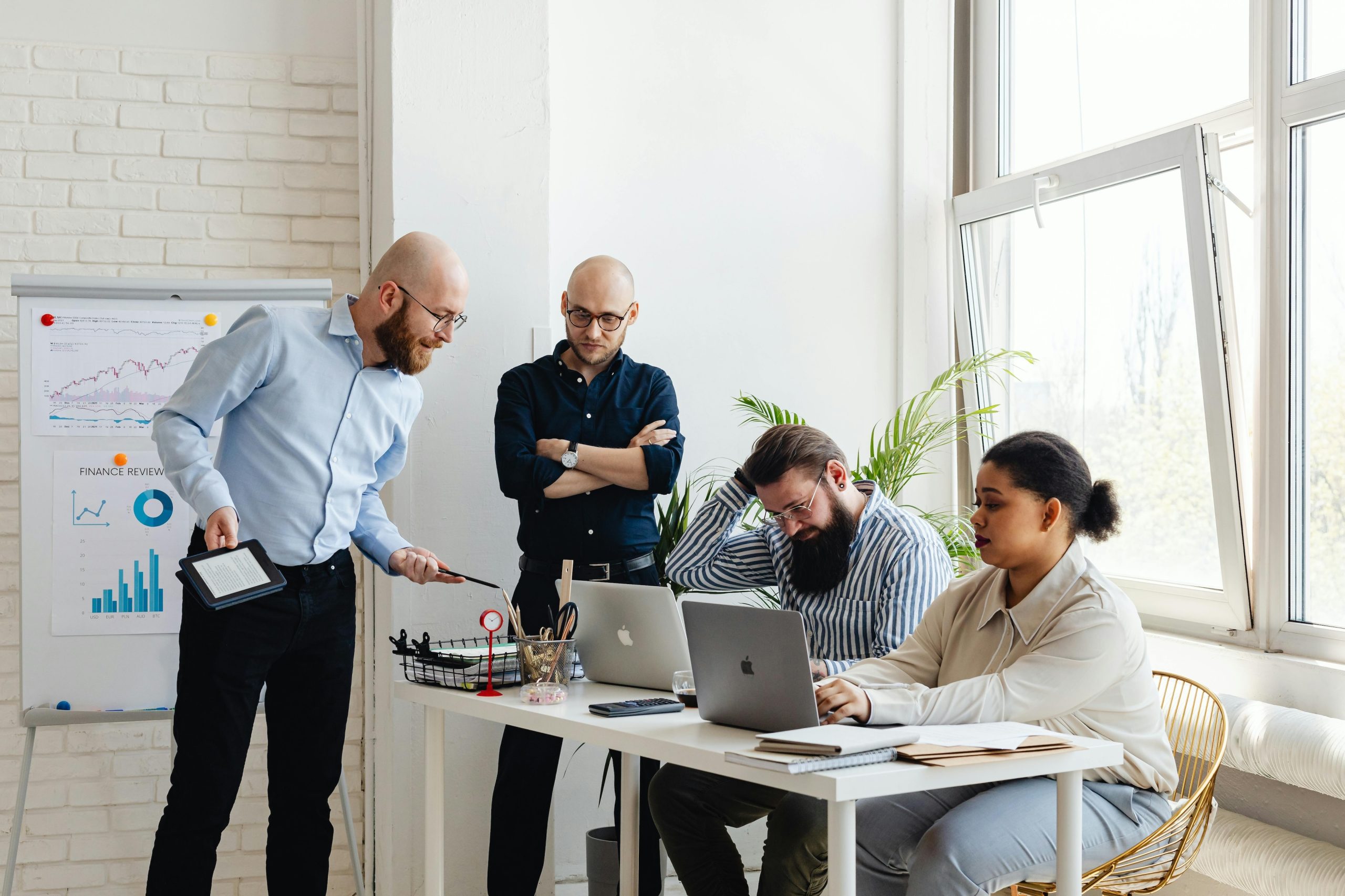 4 people working in an office at a desk