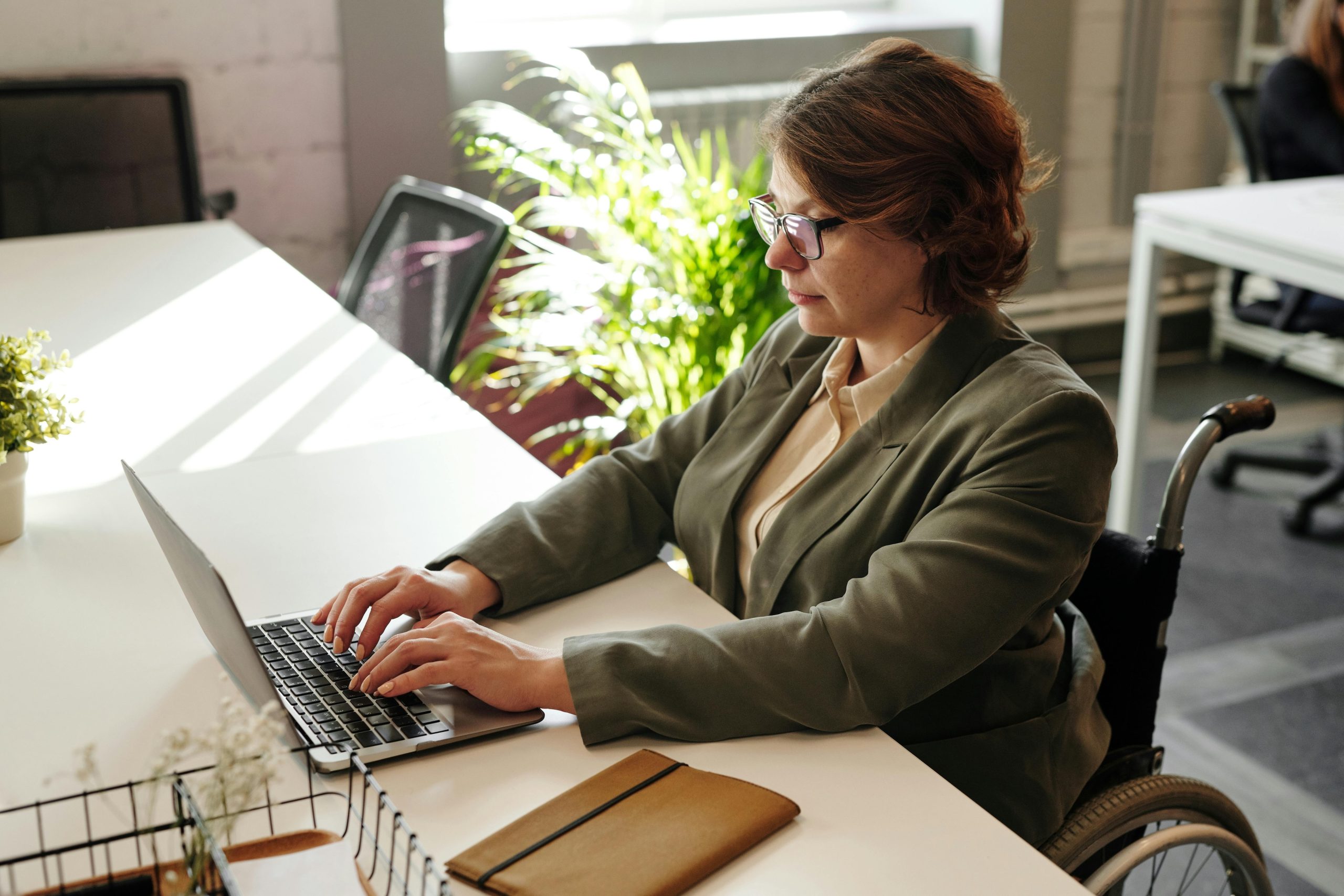 woman working on her laptop at her desk
