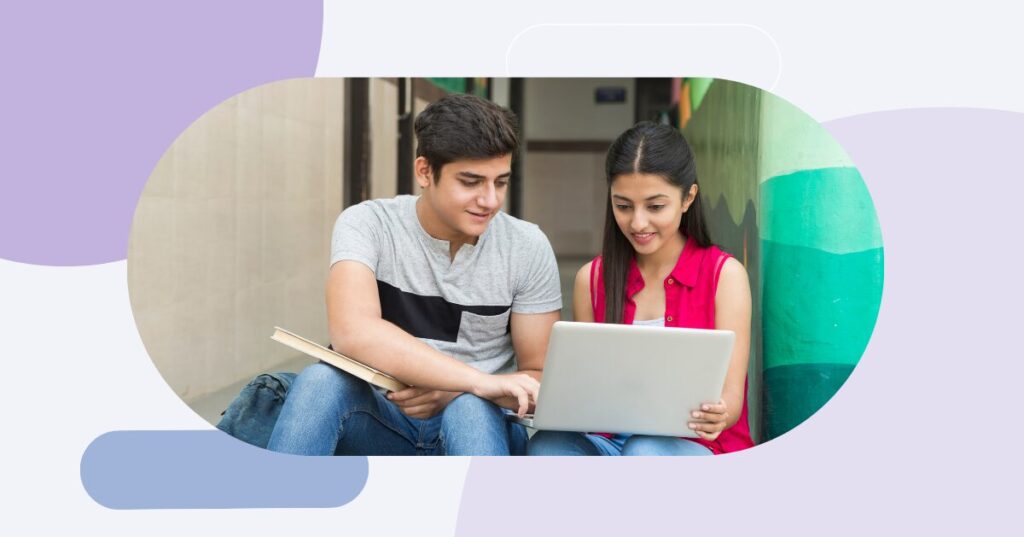 Two people looking at a computer