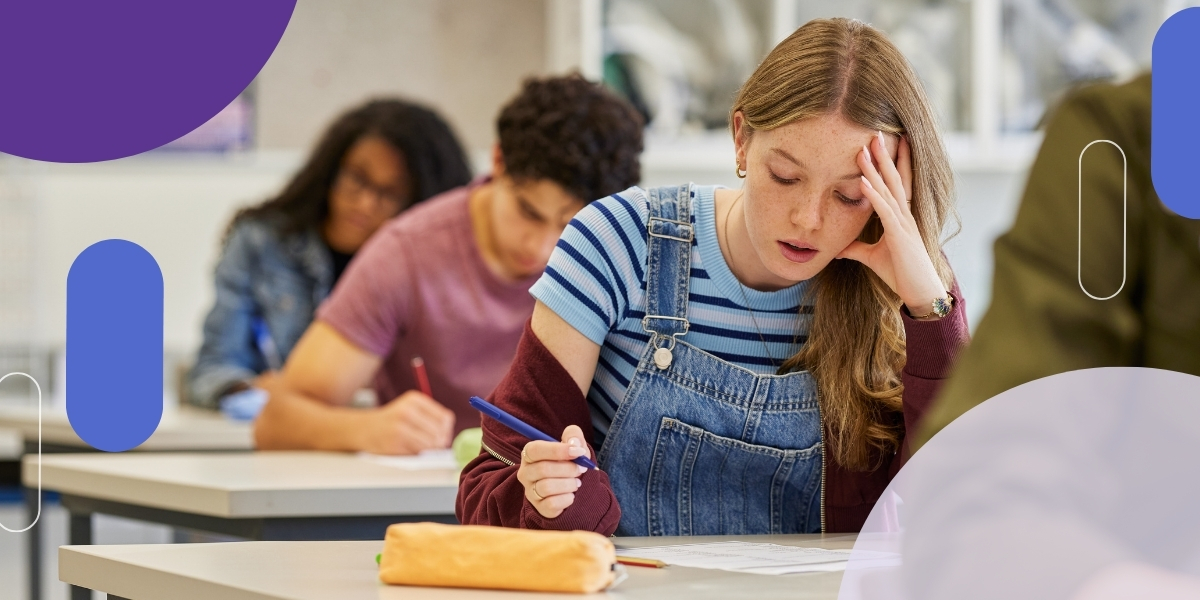 Student looking stressed over a book
