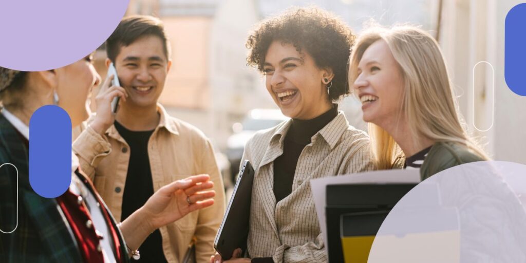 Four people in a group talking and laughing