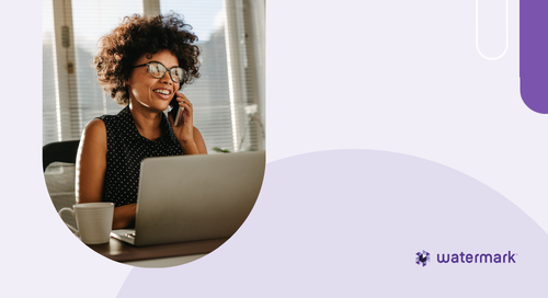 Woman talking on the phone in front of her laptop