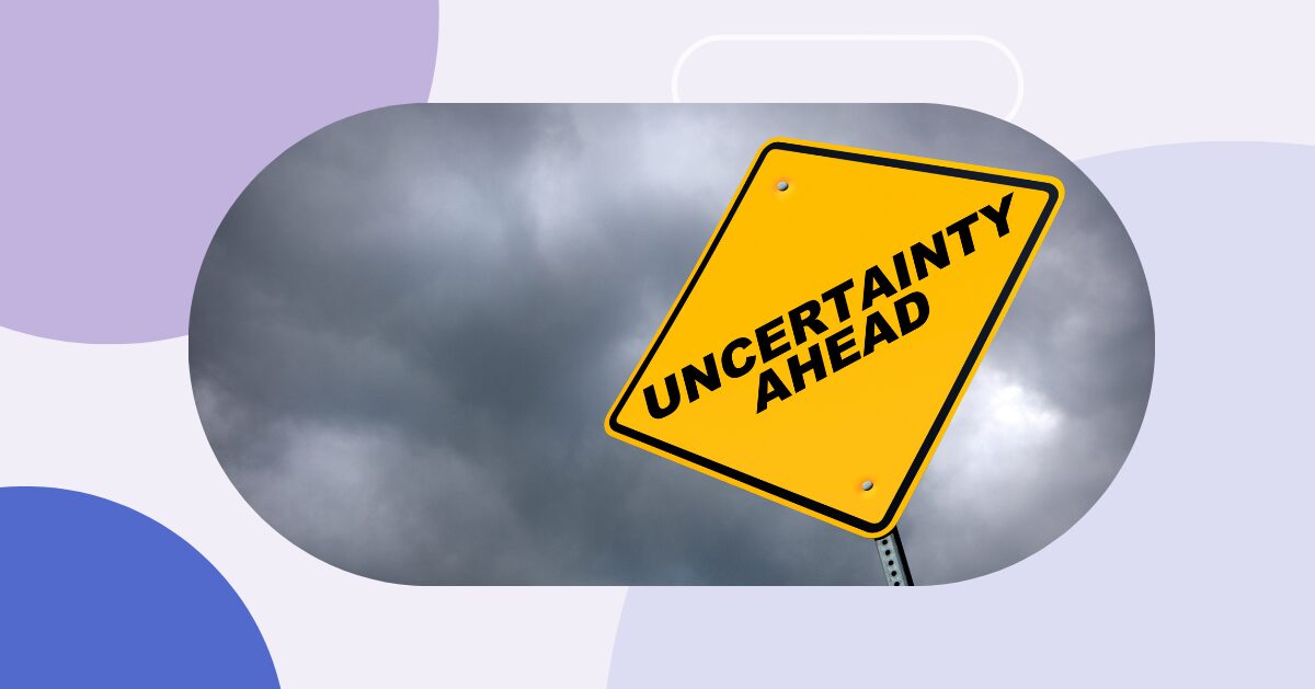 Yield sign against dark, cloudy sky. The sign reads: “Uncertainty ahead”.
