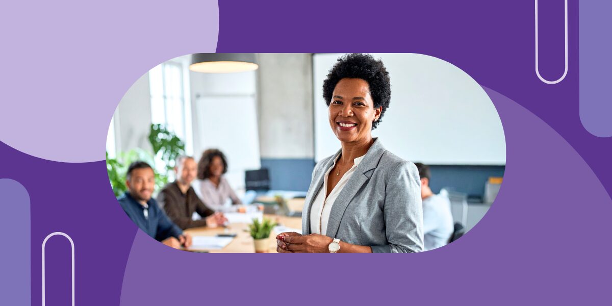 Professional woman leading an academic meeting with colleagues in a conference room.