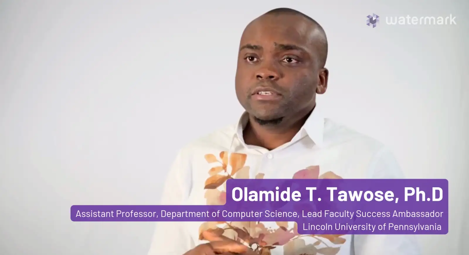 Olamide Tawose being interviewed against a white backdrop with her name and title: &ldquo;Olamide T. Tawose Ph.D., Assistant Professor, Director of Computer Science, Lead Faculty Success Ambassador at Lincoln University of Pennsylvania