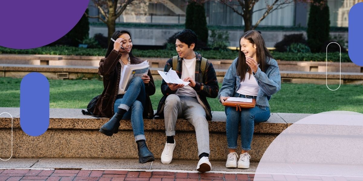 three students sitting and studying